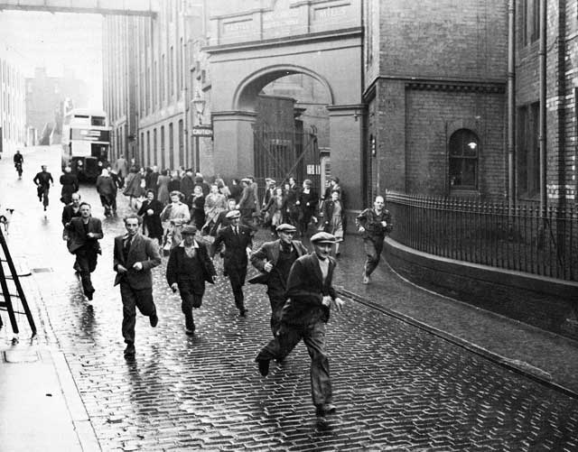 Workers departing from the North British Rubber Company, Fountainbridge at the end of the shift