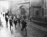 Workers departing from the North British Rubber Company, Fountainbridge at the end of the shift