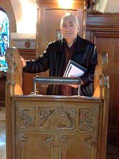 George Robertson standing at the lectern in Robin Chapel in 2009.  George carved this lectern 60 years earlier