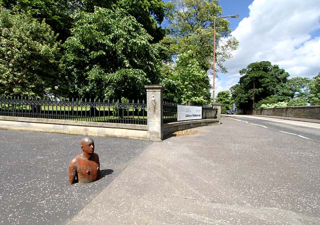 One of the live-size cast iron figures in the artwork '6 Times' by Antony Gormley.  The statues are sited, most in the Water of Leith, between the Scottish National Gallery of Modern Art and Leith Docks