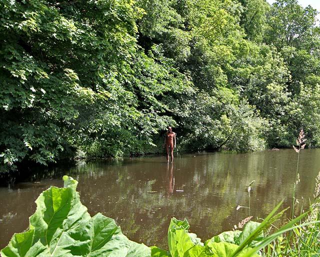 One of the live-size cast iron figures in the artwork '6 Times' by Antony Gormley.  The statues are sited, most in the Water of Leith, between the Scottish National Gallery of Modern Art and Leith Docks