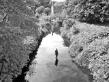 One of the live-size cast iron figures in the artwork '6 Times' by Antony Gormley.  The statues are sited, most in the Water of Leith, between the Scottish National Gallery of Modern Art and Leith Docks