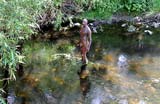 One of the live-size cast iron figures in the artwork '6 Times' by Antony Gormley.  The statues are sited, most in the Water of Leith, between the Scottish National Gallery of Modern Art and Leith Docks