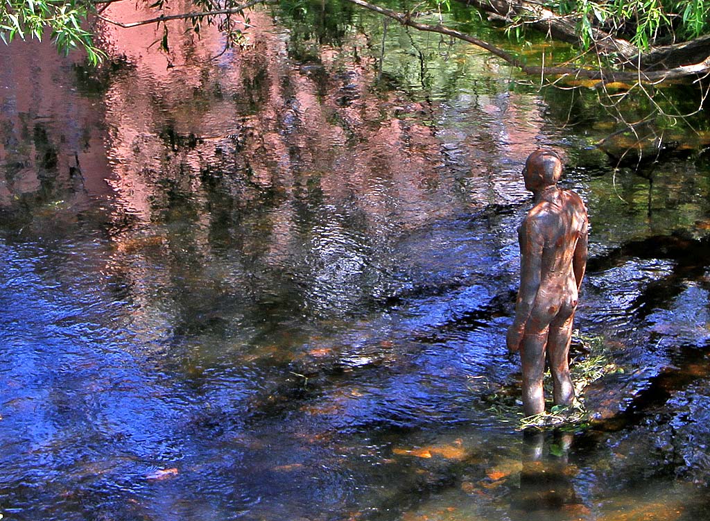 One of the live-size cast iron figures in the artwork '6 Times' by Antony Gormley.  The statues are sited, most in the Water of Leith, between the Scottish National Gallery of Modern Art and Leith Docks