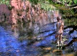 One of the live-size cast iron figures in the artwork '6 Times' by Antony Gormley.  The statues are sited, most in the Water of Leith, between the Scottish National Gallery of Modern Art and Leith Docks