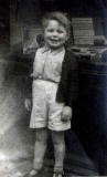 Kenneth G Williamson, contributor to EdinPhoto web site - aged 5, standing outside Southside Train Shop as a child