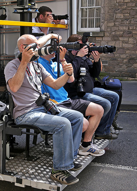 The Press photograph The Queen's Baton as it passes down The Royal Mile on its way to The Scottish Parliament