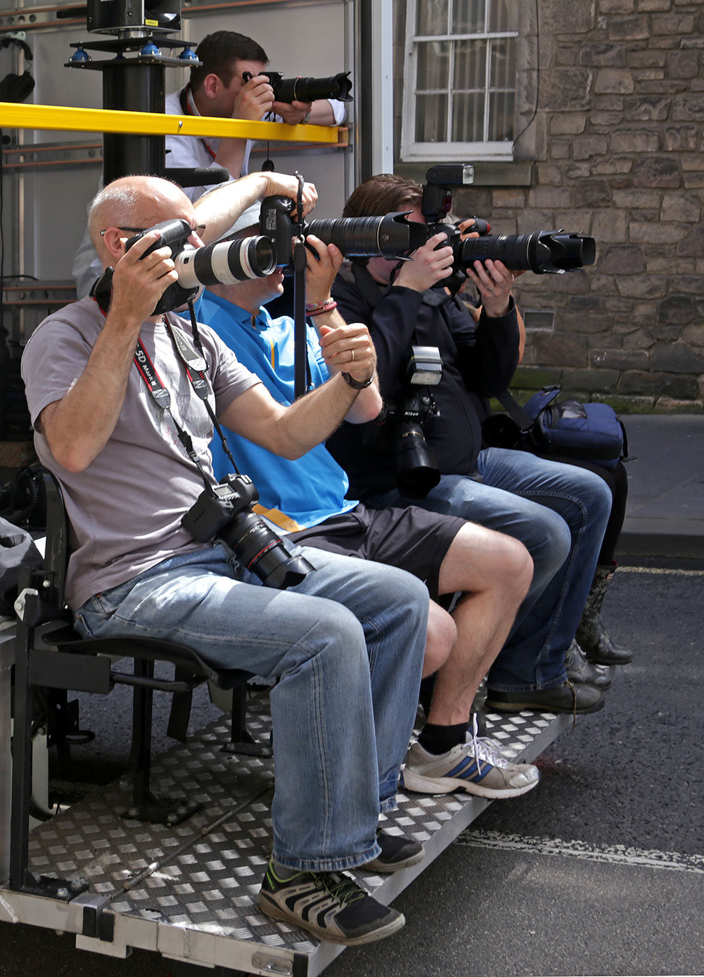 The Press photograph The Queen's Baton as it passes down The Royal Mile on its way to The Scottish Parliament