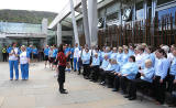 The Queen's Baton emerges from The Scottish Parliament in front of a choir singing in Gaelic