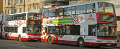 Two buses in Princes Street, showing  older and more recent examples of the Lothian Buses harlequin livery  -  November 2005