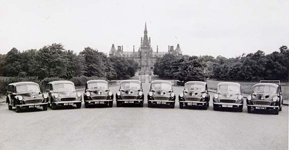 Morris Minors bellonging to Edinburgh Corporation parked in front of Fettes College  -  Photograph probably taken in the 1950s