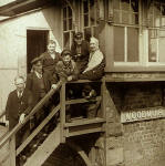 Six railway workers on the steps of Woodmuir Junction Signal Box in West Lothian
