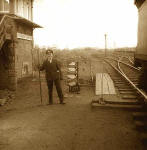 A railway worker stands beside the railway in front of Woodmuir Junction signal box in West Lothian