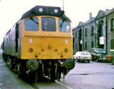 A train passes Granton Harbour and crosses West Harbour Road on its final approach to the Texaco sidings at Granton