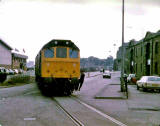 A train passes Granton Harbour and crosses West Harbour Road on its final approach to the Texaco sidings at Granton