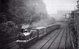 A North British Railways train passes through Princes Street Gardens towards Edinburgh Waverley Station