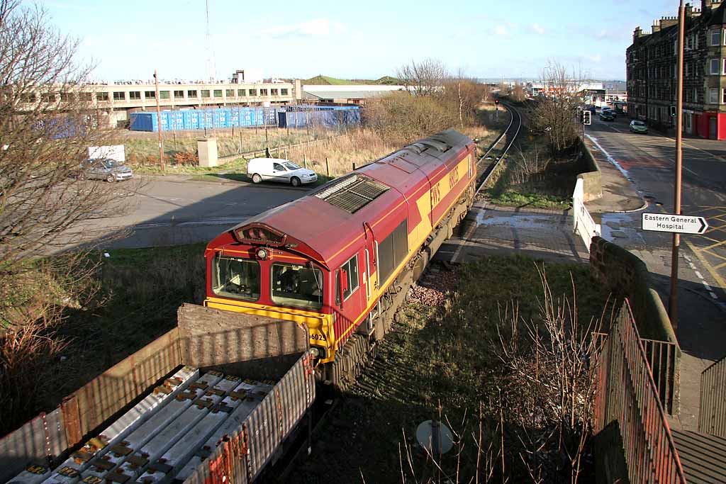 A freight train crosses the level crossing at Seafield, at the junction of Seafield Road and Marine Esplanade, after leaving Leith Docks