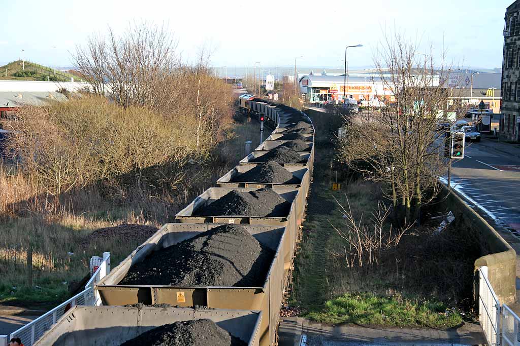 A freight train crosses the level crossing at Seafield, at the junction of Seafield Road and Marine Esplanade, after leaving Leith Docks