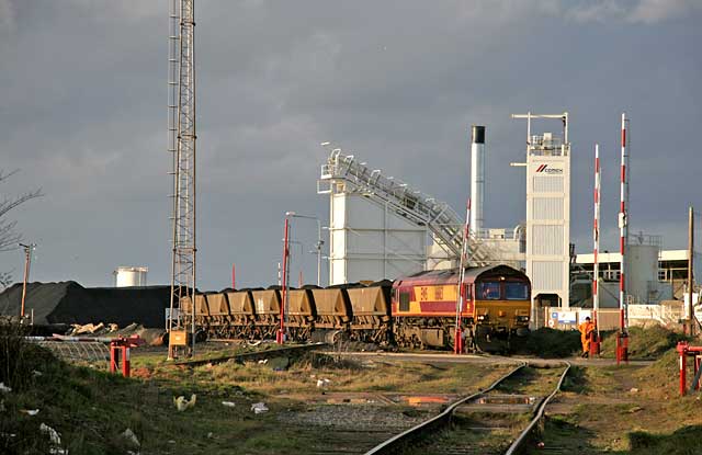 A freight train of wagons now loaded with imported coal stands beside Imperial Dock, Leith, about to depart, possibly for a power statioon