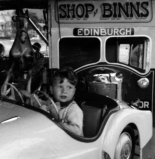 Roundabout at Burntisland with a bus advertising 'Shop at Binns - Edinburgh' - around 1965