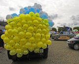 Edinburgh Taxi Trde Children's Outing, 2012  -  Yellow Balloons on the back of one of the Taxis.  The Taxi decorated as a Tank is in the Background