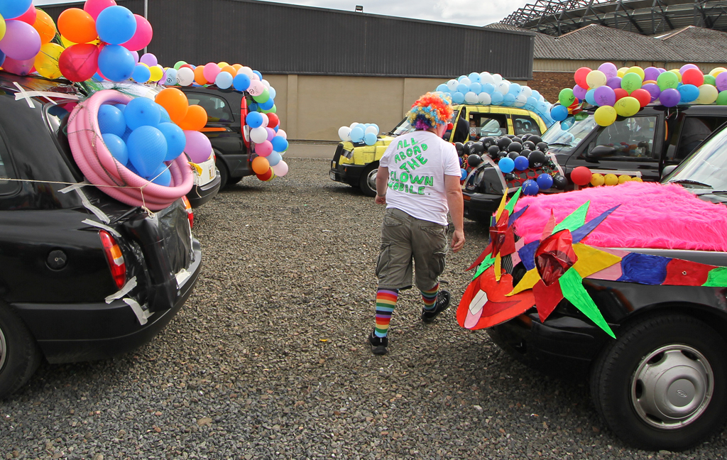 Edinburgh Taxi Trde Children's Outing, 2012  -  Decorated Taxis in the Car Park at Murrayfield, and one Taxi Driver  - "All Aboard the Clown Mobile"