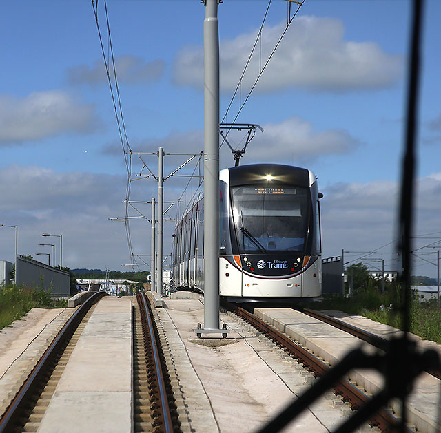 Edinburgh Tram Service  - As the tram leaves Meadowbank tram stop, an approaching tram appears over the brow of the hill, heading for York Place  -  June 2014A wave to the driver of the oncoming tram as the tram approaches Ingliston Park and Ride on its journey to Edinburh Airport Edinburgh Castle is on the horizon -  June 2014