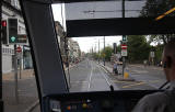 Edinburgh Tram Service  -  A tram continues to wait at the lights before entering Princes Street on its journey to York PlacePrinces Street  -  June 2014