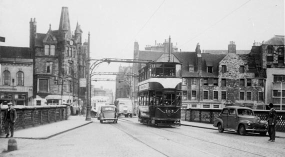 Commercial Street, Leith  -  A tram crosses the bridge over the Water of Leith, heading towards Newahven and Granton.