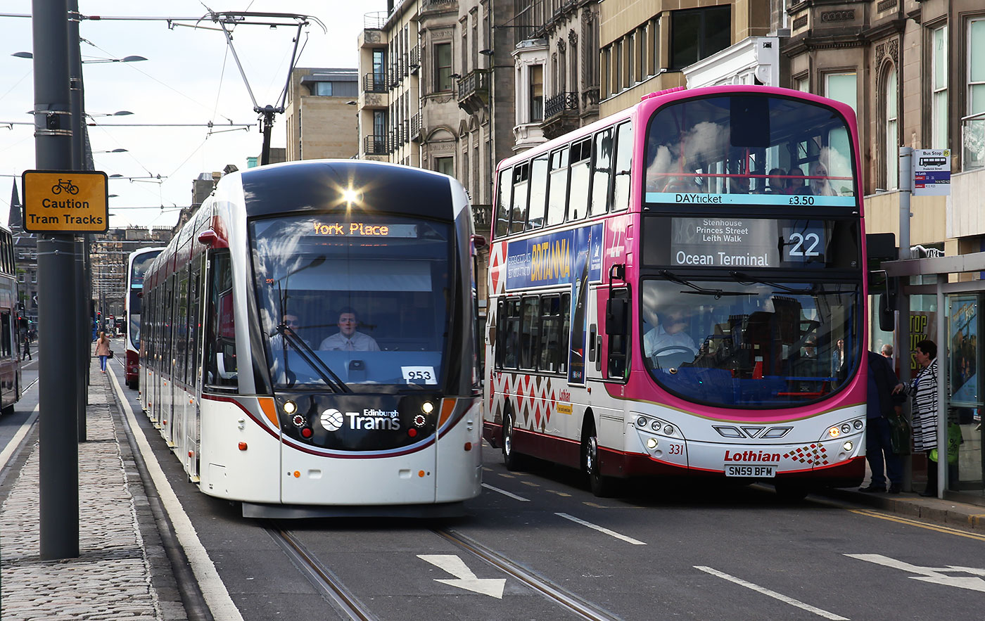 Tram and Bus in Princes Street, mid-March 2014.  The bus is in the new branded livery for Route 26