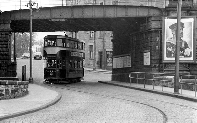 A tram passes under Trinity Bridge in the 1950s.