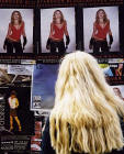 An Edinburgh Festival Visitor stops to read a poster in the Royal Mile