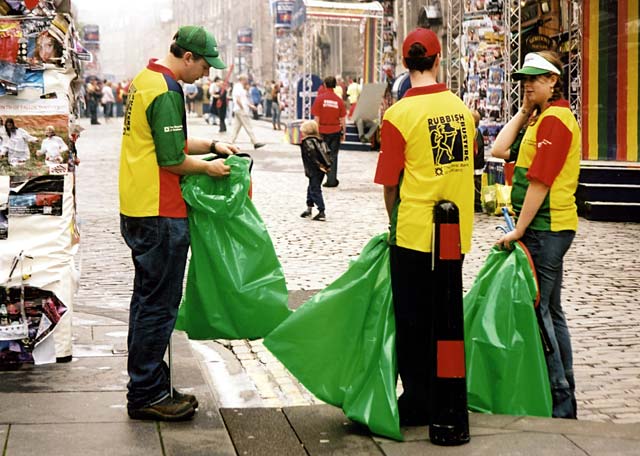 Three litter collectors wait in the Royal Mile at about 10am for the crowds to gather.