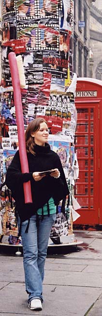 A girl walks down Edinburgh's Royal Mile carrying a large pink toothbrush, promoting the show 'Bedtime Stories' being performed by Les Enfants Terribles Theatre Company.