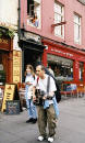 A guitarist and singer pause as they pass Burnet's Close in the Royal Mile, Edinburgh