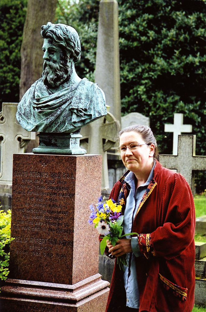 Sara Stevenson about to lay flowers on the gravestone of DO Hill to commemorate the bi-centenary of his birth