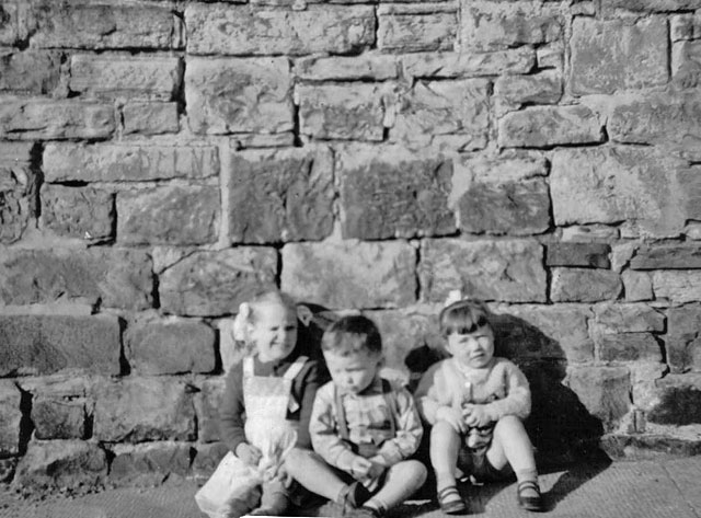 Three young children at the wall in Bedford Street, Stockbridge