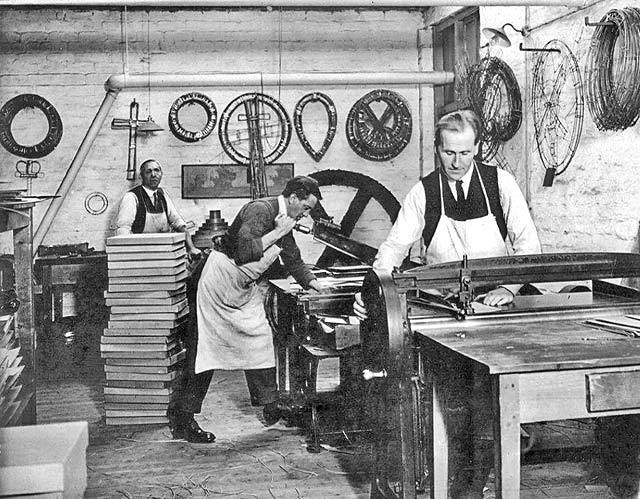 Lady Haig's Factory at the Canongate:  Men working, one on the guillotine