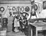 Lady Haig's Factory at the Canongate:  Men working, onte on the guillotine