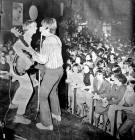 Two of the Moonrakers pop group performing on stage at Magoos in the 1960s