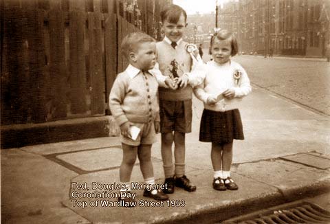 Ted, Douglas and Margaret Garry at the top of Wardlaw Street, Gorgie, on their way to a Coronation Party in 1953.