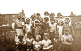 A group of 21 children on the back green behind West Pilton Crossway, 1955