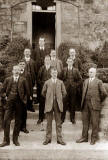 Ten men on the steps, wearing waistcoats and pocket watches  -  Who?  When?  Where?