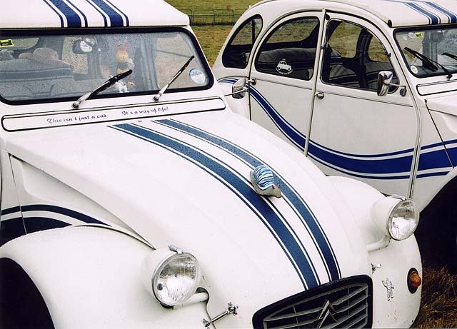 Citroen 2CV cars  in the grounds of Floors Castle,  Kelso, in the Scottish Borders  -  during the World 2CV Meeting held at Kelso, July 2005