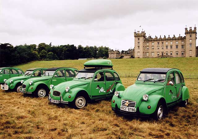 Citroen 2CV cars  in the grounds of Floors Castle,  Kelso, in the Scottish Borders  -  during the World 2CV Meeting held at Kelso, July 2005