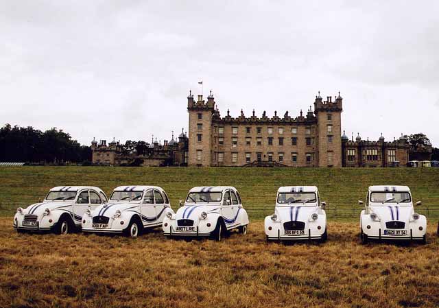 Citroen 2CV cars  in the grounds of Floors Castle,  Kelso, in the Scottish Borders  -  during the World 2CV Meeting held at Kelso, July 2005
