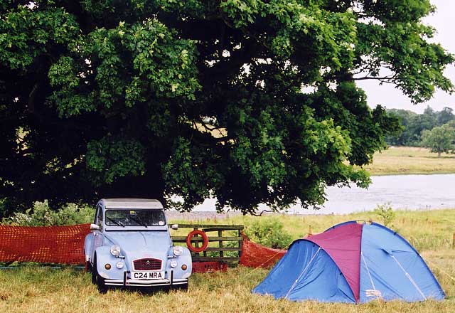A Citroen 2CV in the grounds of Floors Castle,  Kelso, in the Scottish Borders  -  during the World 2CV Meeting held at Kelso, July 2005