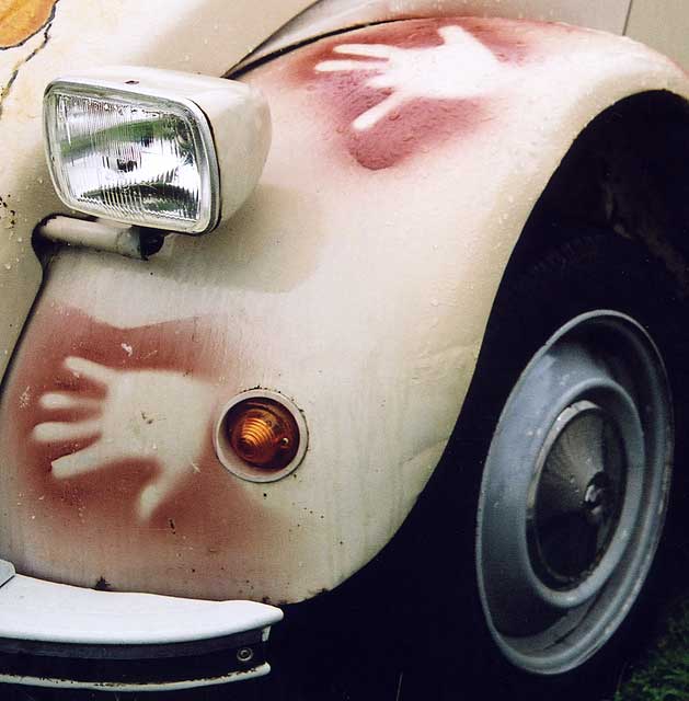 Zoom-in to see details on the front wing of a  Citroen 2CV in the grounds of Floors Castle,  Kelso, in the Scottish Borders  -  during the World 2CV Meeting held at Kelso, July 2005