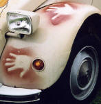 Zoom-in to see detail on the front wing of a  Citroen 2CV in the grounds of Floors Castle,  Kelso, in the Scottish Borders  -  during the World 2CV Meeting held at Kelso, July 2005