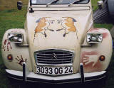Zoom-out to see the front of a Citroen 2CV in the grounds of Floors Castle, Kelso in the Scottish Borders  -  during the World 2CV Meeting held at Kelso, July 2005
